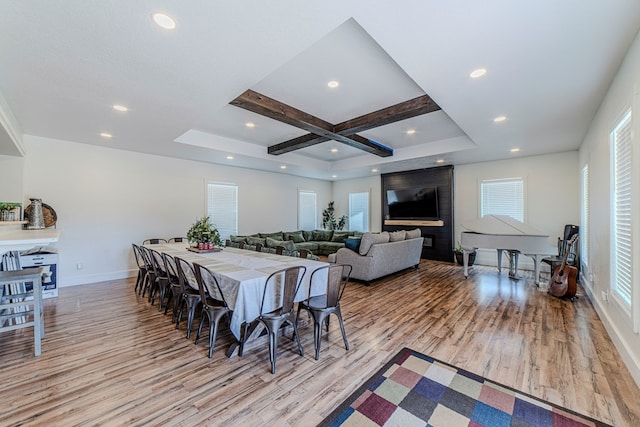 dining space with beamed ceiling, light wood-type flooring, and coffered ceiling