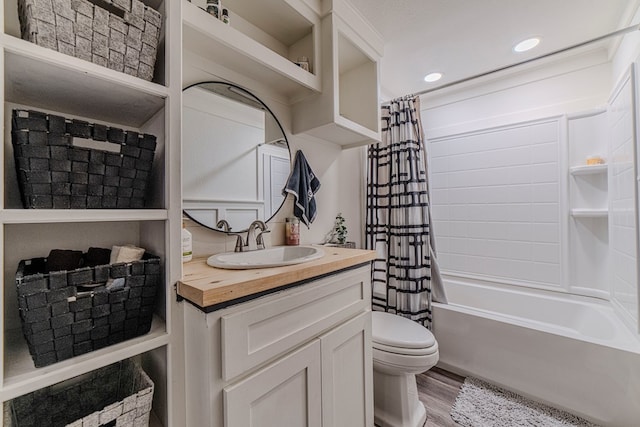 full bathroom featuring vanity, hardwood / wood-style flooring, toilet, and shower / bath combo with shower curtain