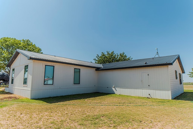 back of property with a lawn