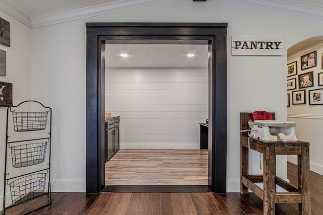 details featuring hardwood / wood-style floors, ornamental molding, and wood walls