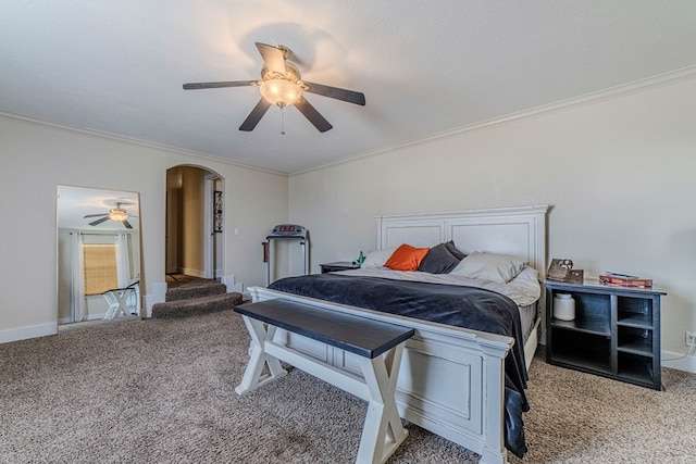 bedroom with carpet flooring, ceiling fan, and crown molding