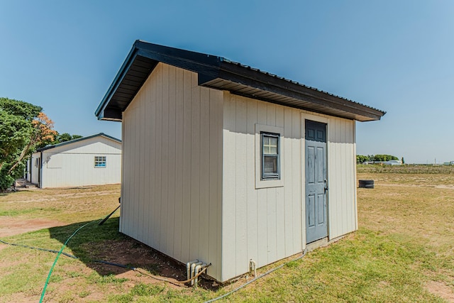 view of outbuilding with a lawn