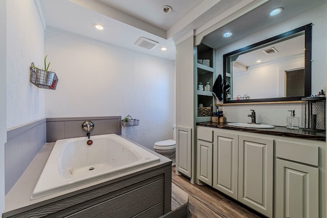 bathroom featuring a washtub, wood-type flooring, vanity, and toilet