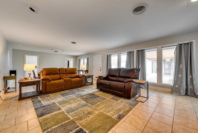 tiled living room featuring recessed lighting and visible vents