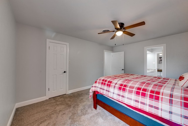 bedroom featuring visible vents, baseboards, ensuite bathroom, ceiling fan, and carpet flooring