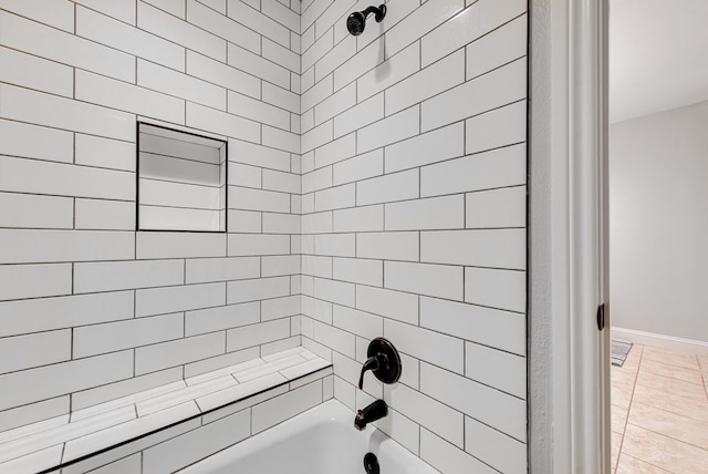bathroom with washtub / shower combination and baseboards
