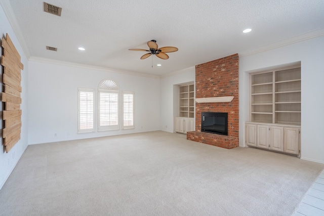 5500 Drexel, Midland, TX 79707 - unfurnished living room featuring ceiling fan, a brick fireplace, crown molding, built in features, and a textured ceiling