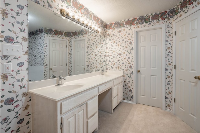 5500 Drexel, Midland, TX 79707 - bathroom with wallpapered walls, double vanity, and a textured ceiling