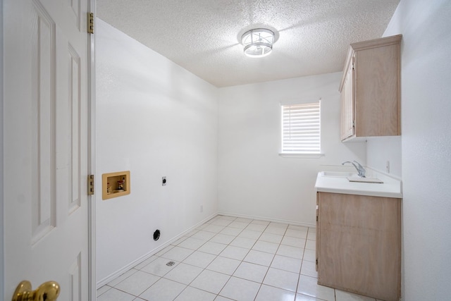 5500 Drexel, Midland, TX 79707 - laundry area with electric dryer hookup, washer hookup, cabinet space, a textured ceiling, and light tile patterned floors