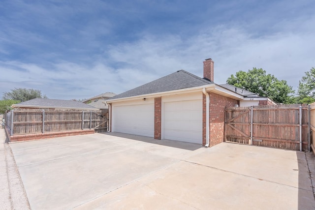 5500 Drexel, Midland, TX 79707 - view of side of home featuring brick siding, a chimney, a garage, and roof with shingles