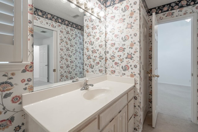 5500 Drexel, Midland, TX 79707 - bathroom with wallpapered walls, vanity, and a textured ceiling