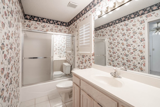 5500 Drexel, Midland, TX 79707 - full bath featuring wallpapered walls, a textured ceiling, vanity, tile patterned flooring, and bath / shower combo with glass door