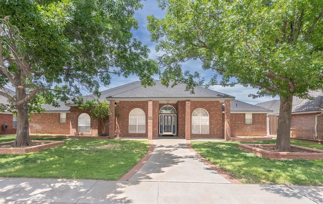 5500 Drexel, Midland, TX 79707 - view of front of property with brick siding, a front yard, and a shingled roof