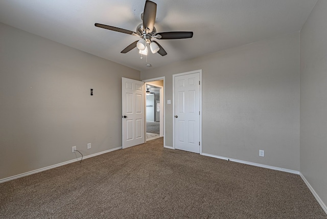 interior space featuring baseboards, ceiling fan, freestanding refrigerator, and carpet flooring