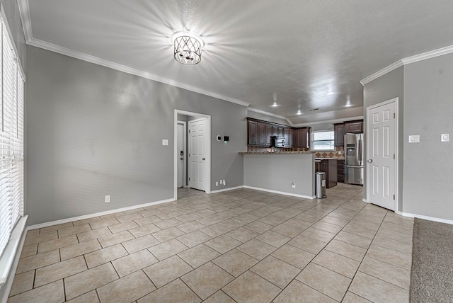 unfurnished living room with baseboards, ornamental molding, and light tile patterned floors