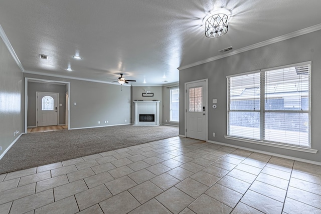 unfurnished living room featuring visible vents, tile patterned flooring, a fireplace, a textured ceiling, and a ceiling fan
