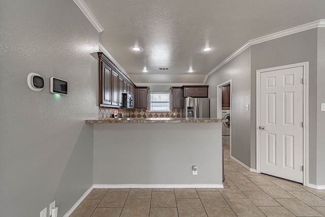 kitchen with crown molding, dark brown cabinets, light tile patterned flooring, appliances with stainless steel finishes, and washer / dryer