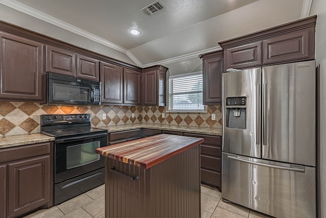 kitchen with visible vents, crown molding, light tile patterned floors, black appliances, and wood counters