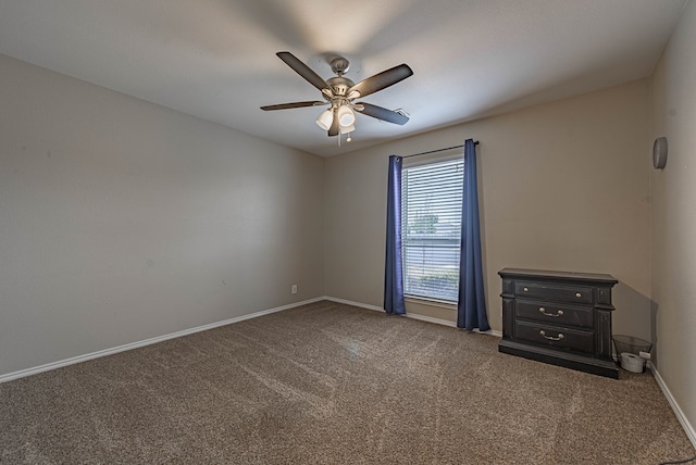 empty room featuring carpet floors, a ceiling fan, and baseboards