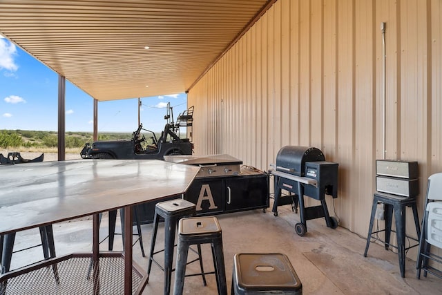 view of patio / terrace featuring an outdoor bar and a grill