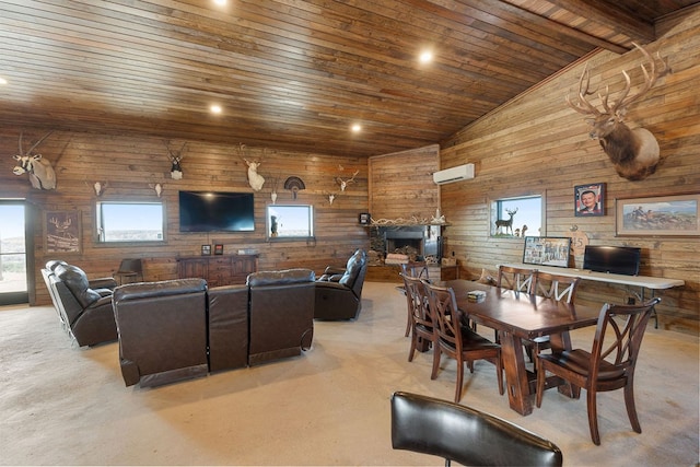 dining area with wood walls, a stone fireplace, an AC wall unit, vaulted ceiling, and wood ceiling