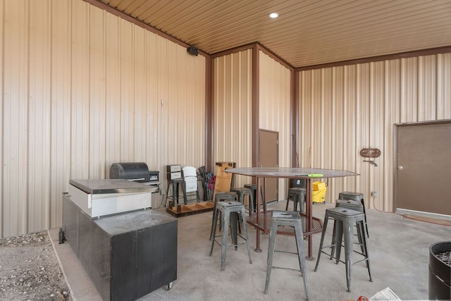 misc room featuring wooden ceiling and wooden walls