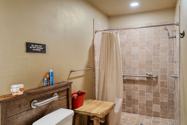 bathroom with a shower with curtain and toilet