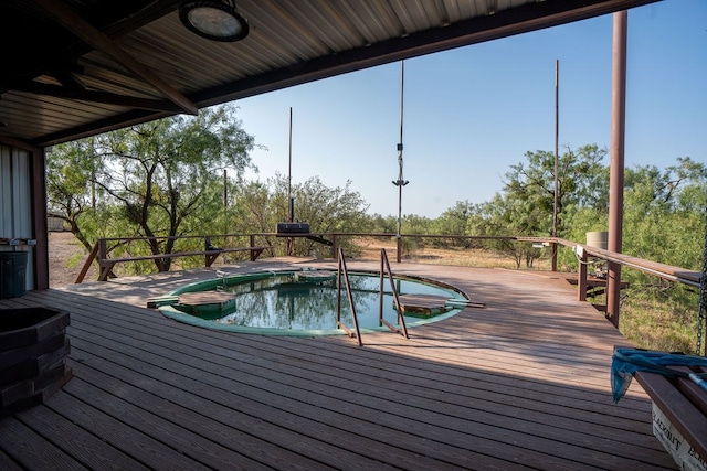 view of pool with a hot tub and a deck