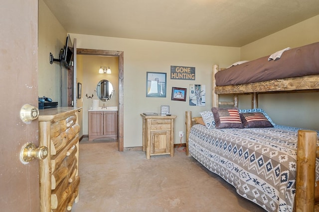 bedroom with connected bathroom, light carpet, and sink