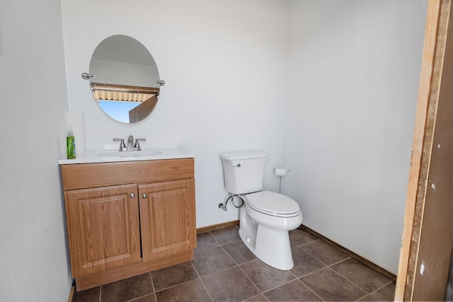 bathroom featuring tile patterned floors, vanity, and toilet