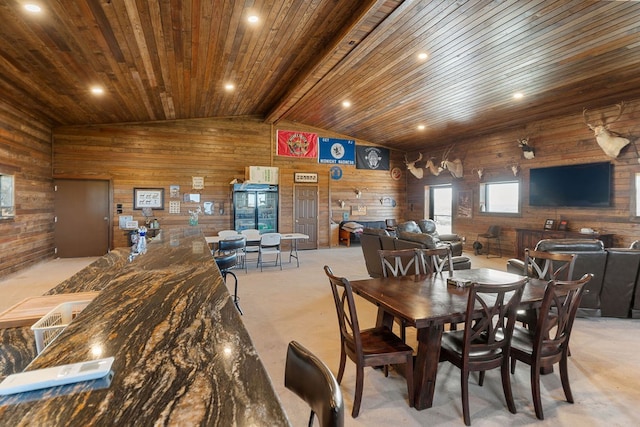 carpeted dining room featuring lofted ceiling with beams, wood ceiling, and wooden walls