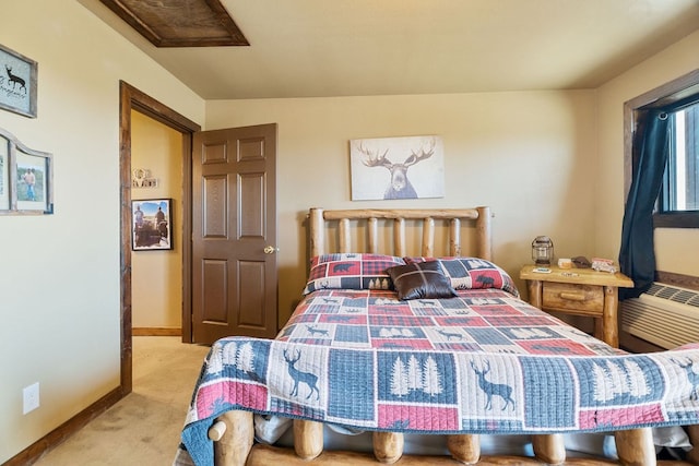 bedroom featuring a wall mounted air conditioner and light colored carpet