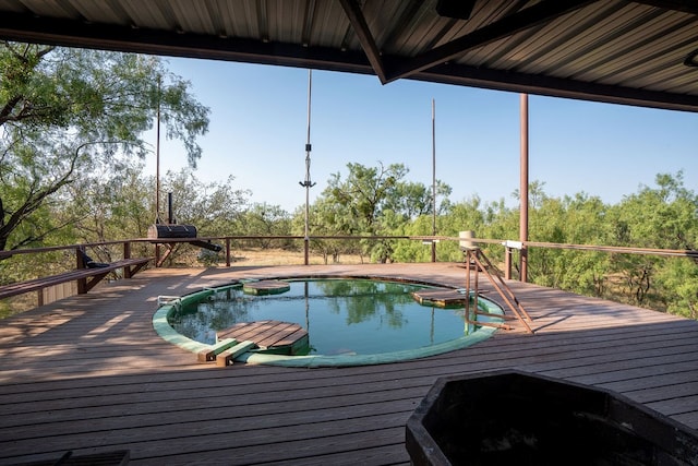 view of swimming pool featuring a deck