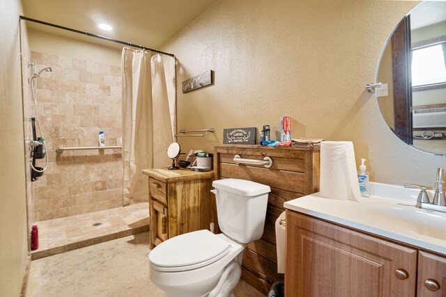 bathroom with toilet, vanity, and walk in shower