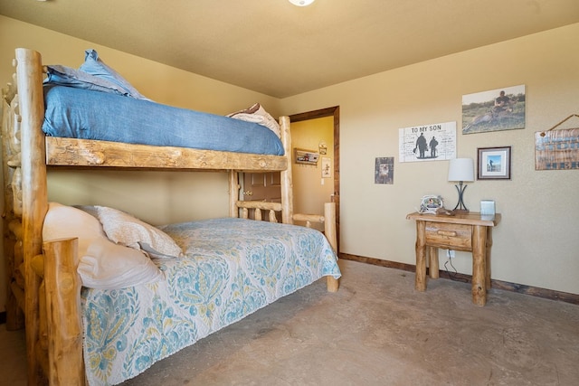 bedroom featuring concrete flooring