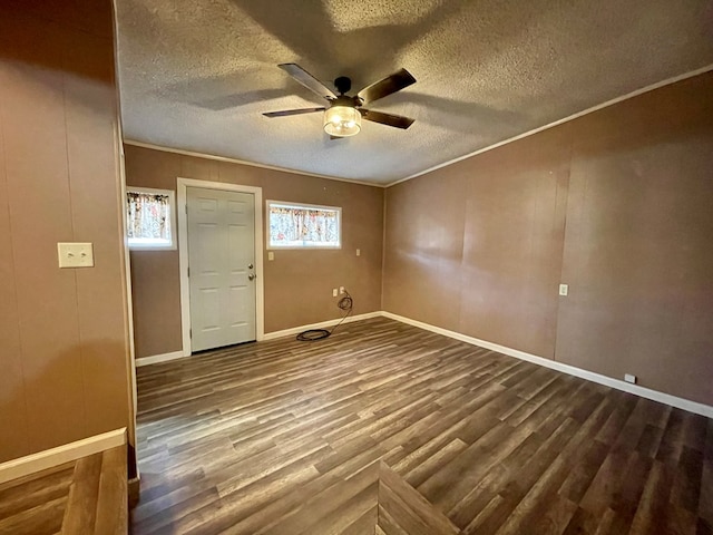2508 31st St, Snyder, TX 79549 - unfurnished room featuring ornamental molding, dark wood-type flooring, a textured ceiling, and ceiling fan