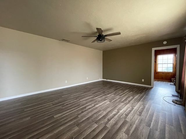 spare room with ceiling fan, dark hardwood / wood-style flooring, and a textured ceiling