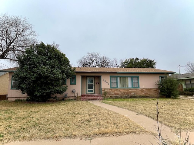 ranch-style home with a front lawn