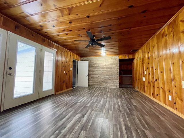 2508 31st St, Snyder, TX 79549 - unfurnished living room featuring dark hardwood / wood-style flooring, wood ceiling, and wooden walls