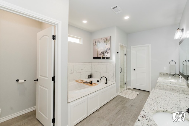 bathroom with wood-type flooring, vanity, and separate shower and tub