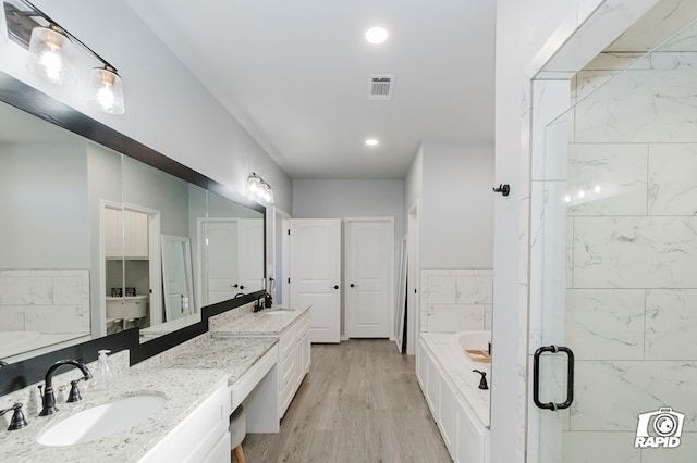 bathroom with vanity, wood-type flooring, and shower with separate bathtub