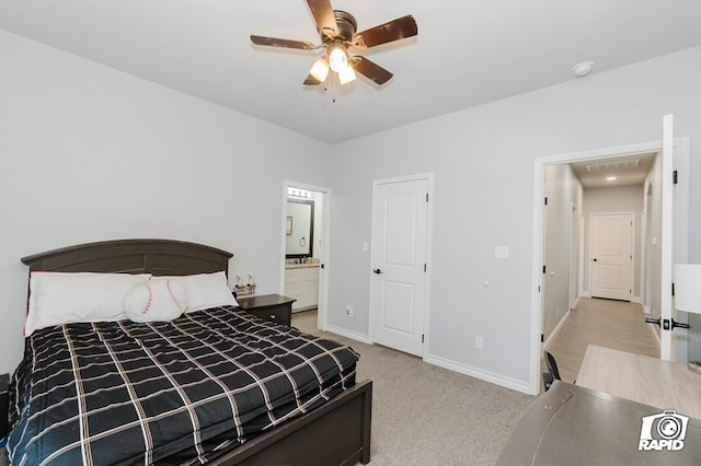 carpeted bedroom with connected bathroom and ceiling fan