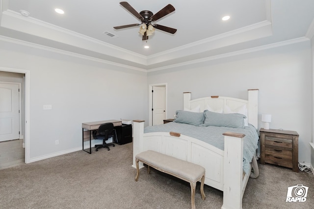 carpeted bedroom featuring a tray ceiling, ceiling fan, and ornamental molding