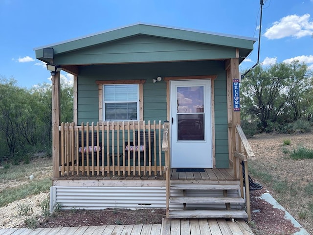 shotgun-style home featuring covered porch