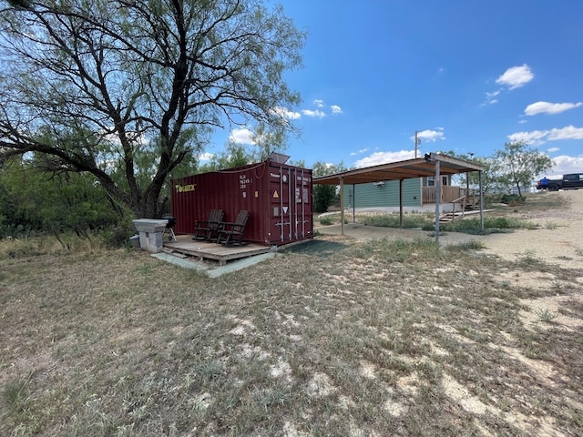 view of outdoor structure with a detached carport and an outbuilding