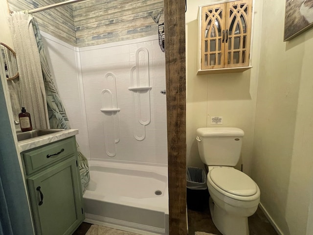 full bathroom featuring toilet, baseboards, and a tile shower