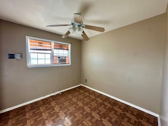 unfurnished room featuring baseboards, ceiling fan, and an AC wall unit