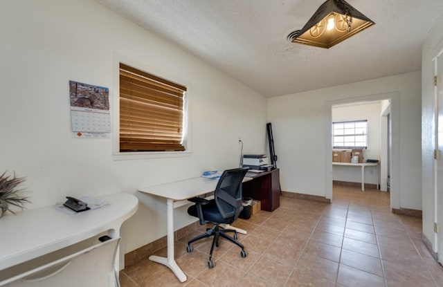 tiled home office featuring a textured ceiling