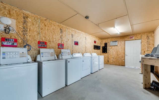 laundry room with washing machine and dryer and a wall mounted air conditioner