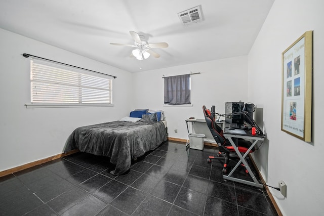 bedroom with a ceiling fan, granite finish floor, baseboards, and visible vents